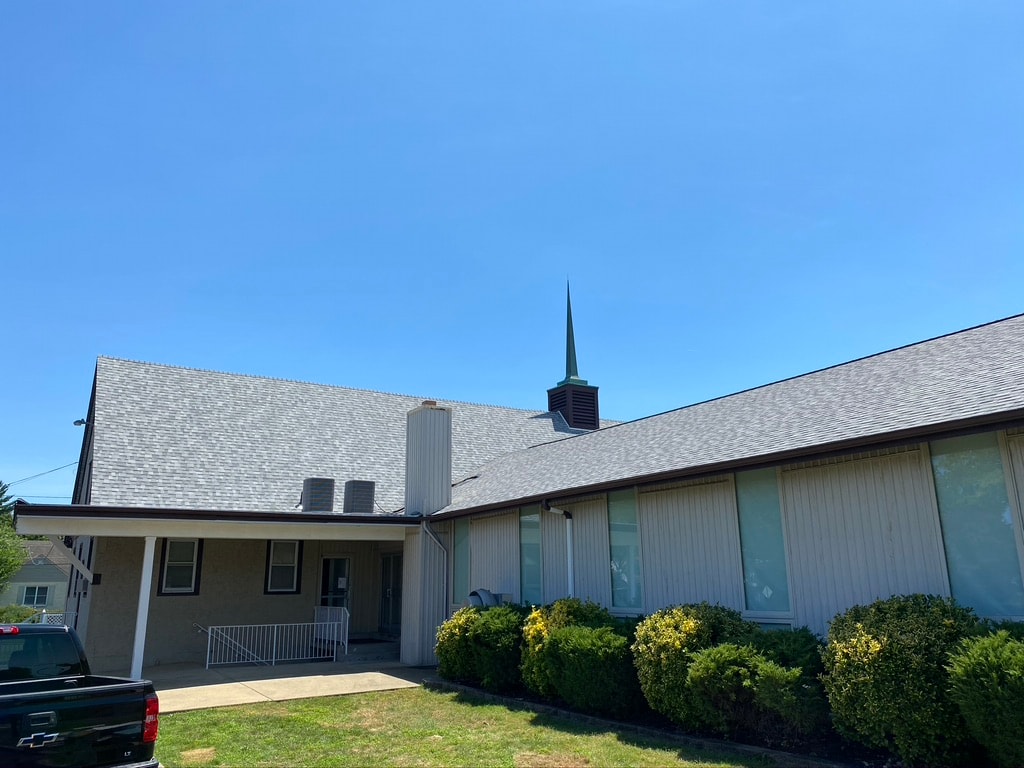 Full view of completed church roof replacement with CrossWay Community Church sign