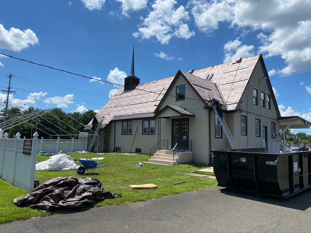 Ice and water shield underlayment being installed on church roof