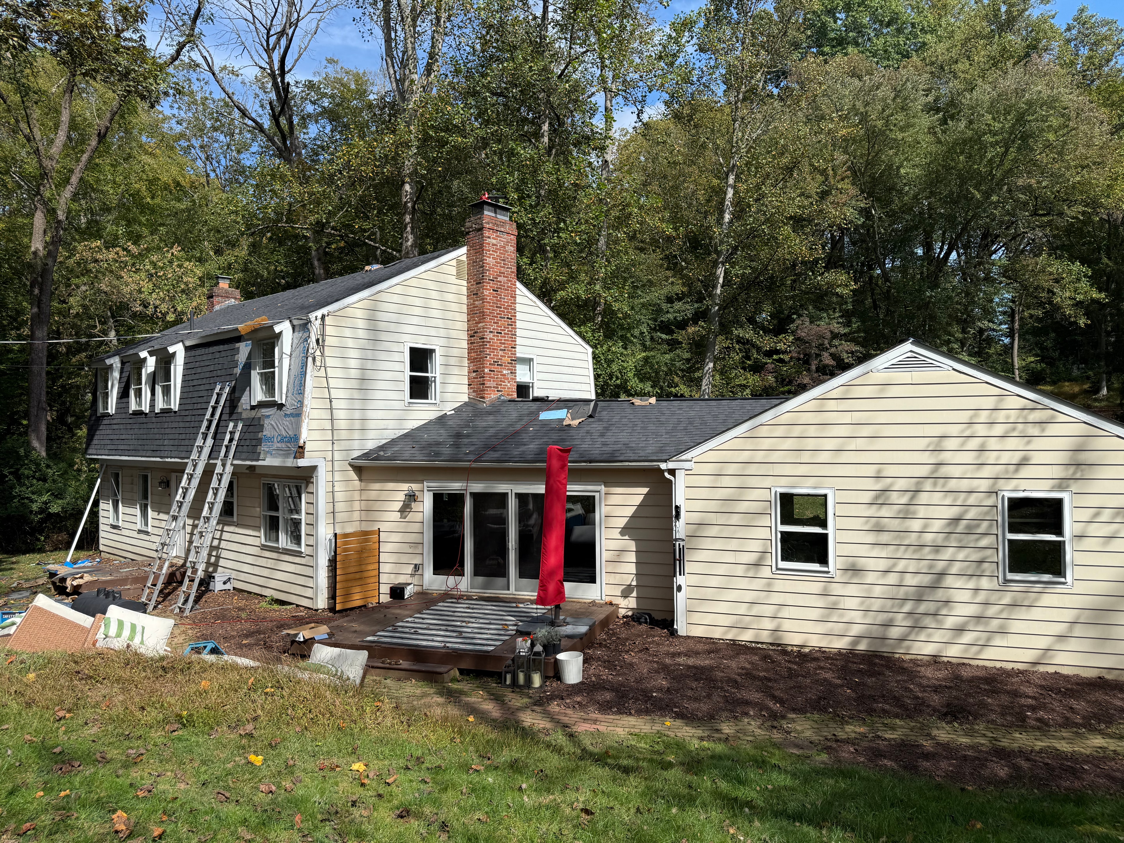 Rear roofline with Moire Black shingles partially installed