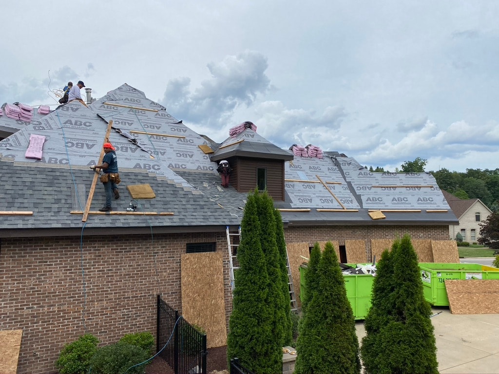 Estate Grey shingles being installed on complex multi-gable roof