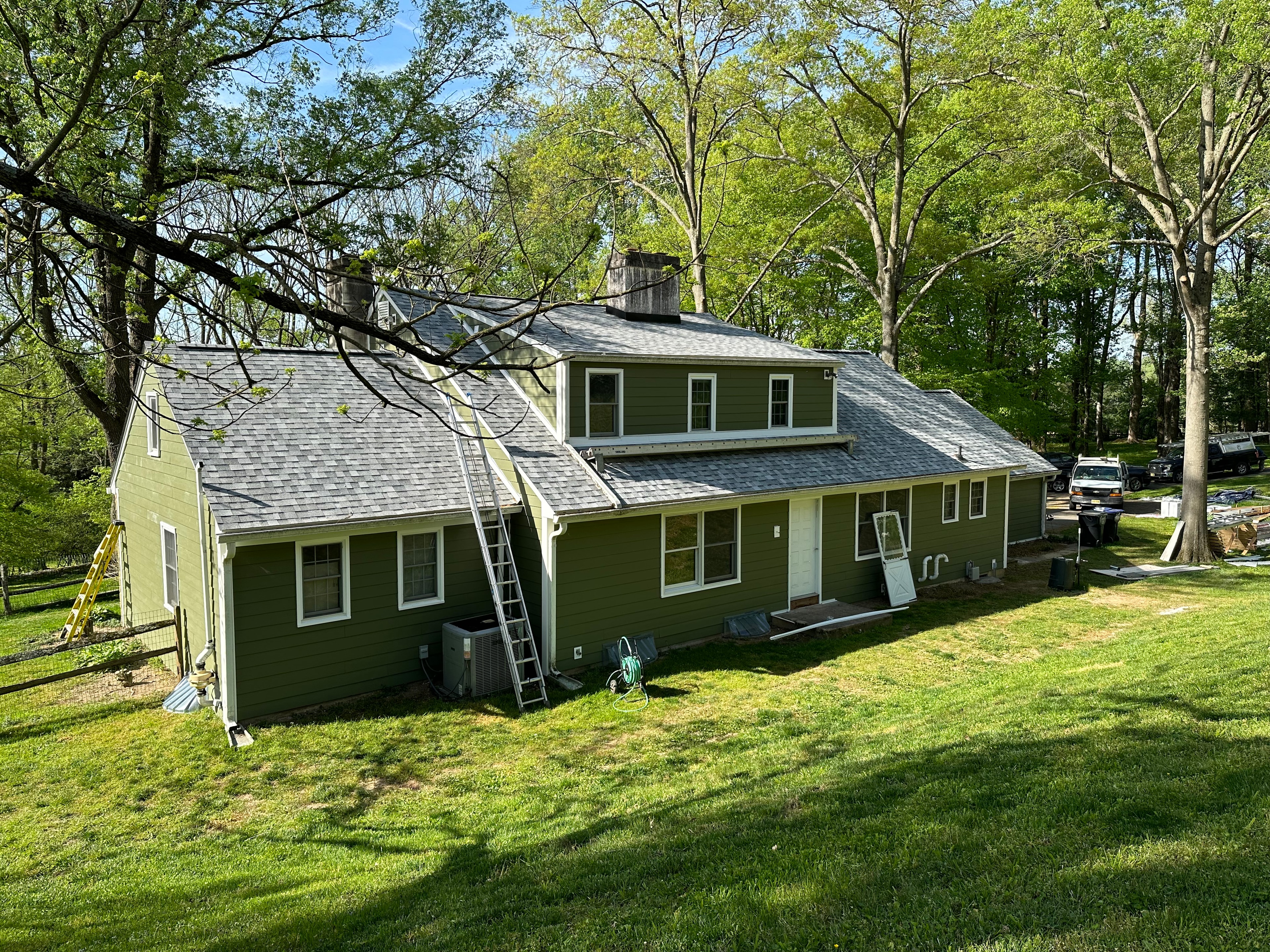 Wide rear view of completed West Chester home showing full Mountain Sage Hardie siding and Sierra Grey roof