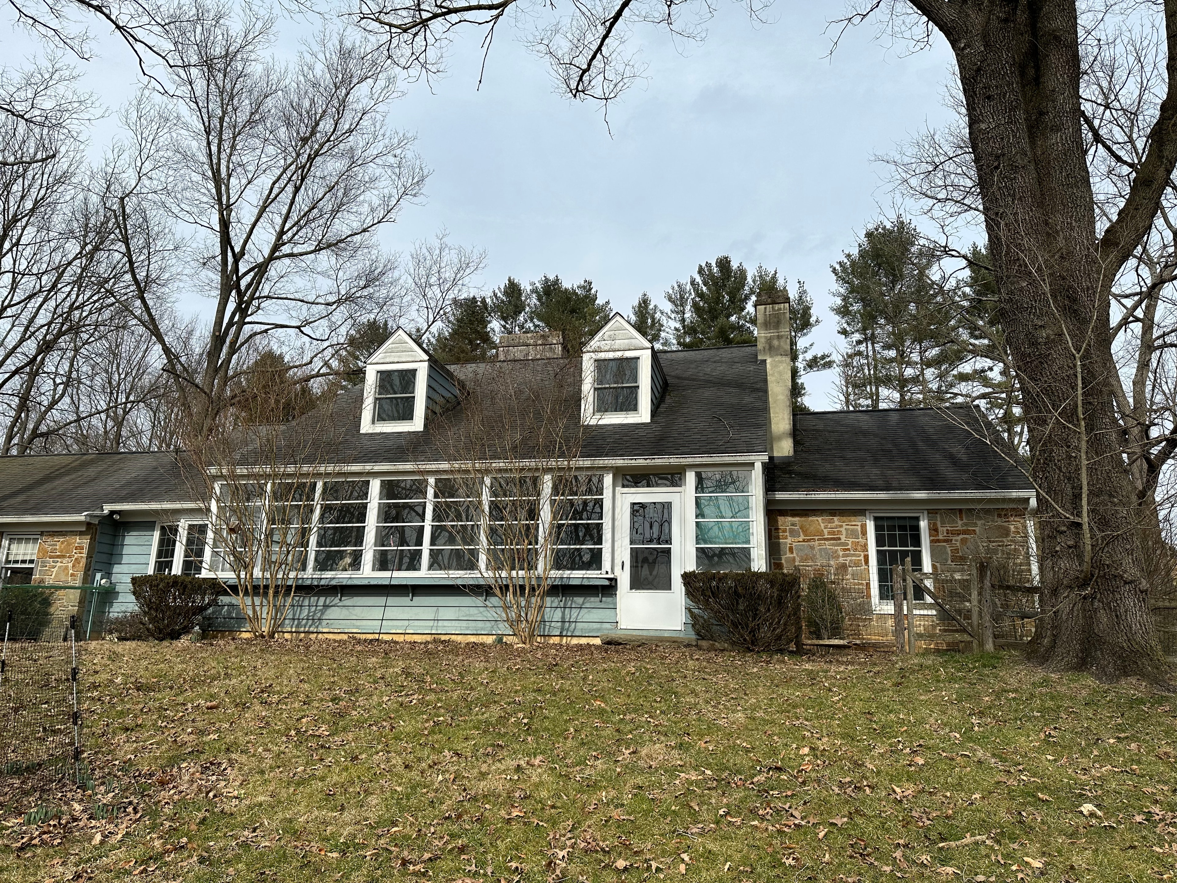 Front elevation of West Chester home with original blue siding and old dark shingles before replacement
