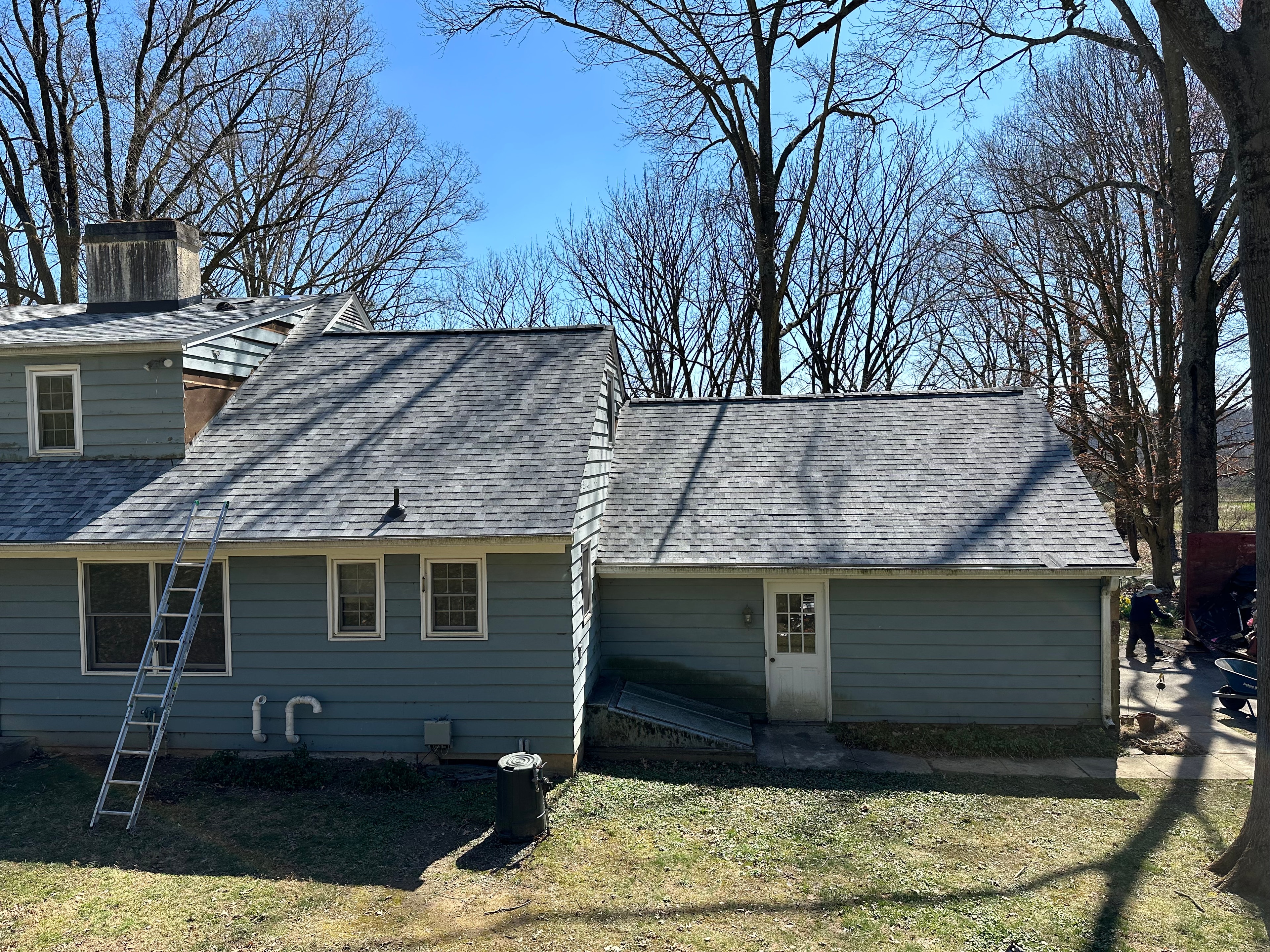 Crew installing Mountain Sage James Hardie siding on West Chester home with new roof complete